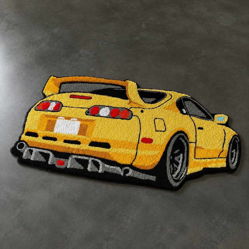 Yellow hand-tufted car rug shaped like a 90s Japanese sports coupe seen from the rear