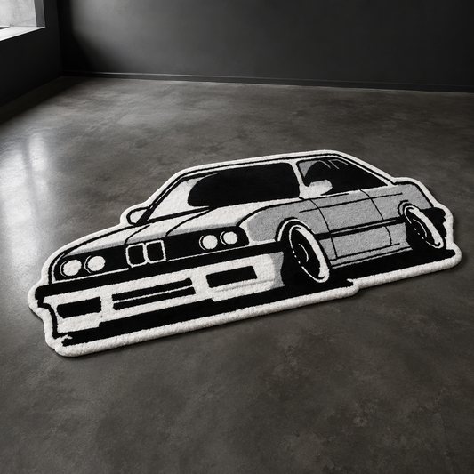 Black and white hand-tufted car rug shaped like a 1980s European coupe