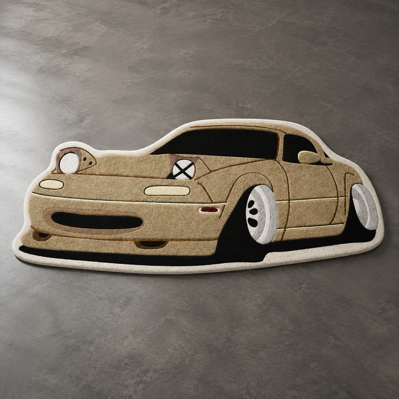 Sand coloured hand-tufted car rug shaped like a small Japanese roadster with pop-up headlights